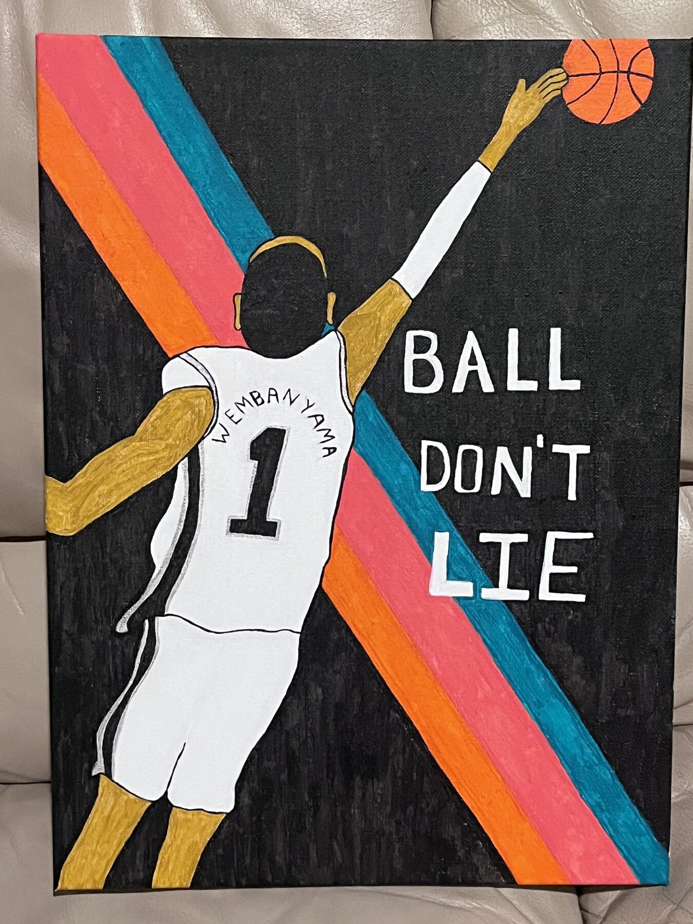 Victor Wembanyama dunking beneath the words "Ball Don't Lie," acrylic on canvas